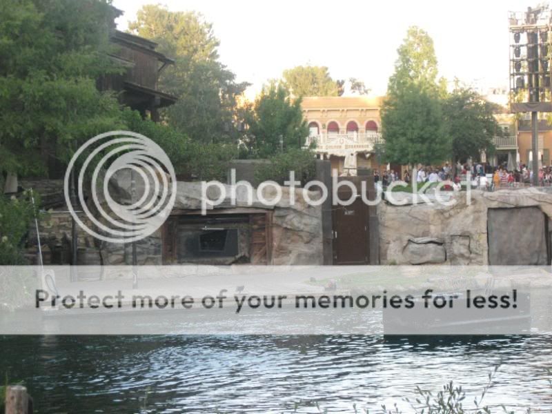 In this picture you can clearly see the door that hides the projector in the day that opens prior to Fantasmic!  This projector is what shoots imagery onto the waterscreens.